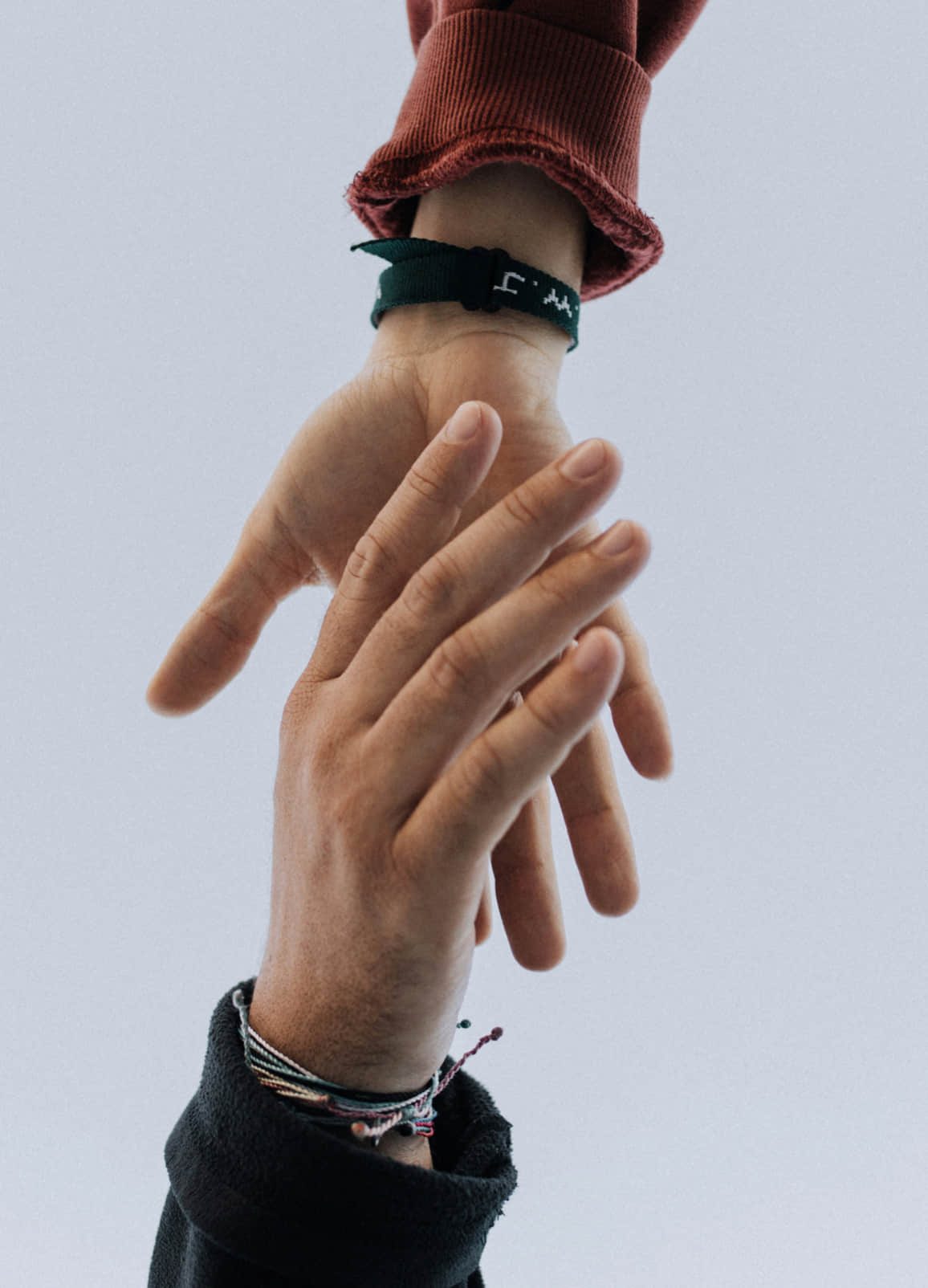 Two hands reaching toward one another